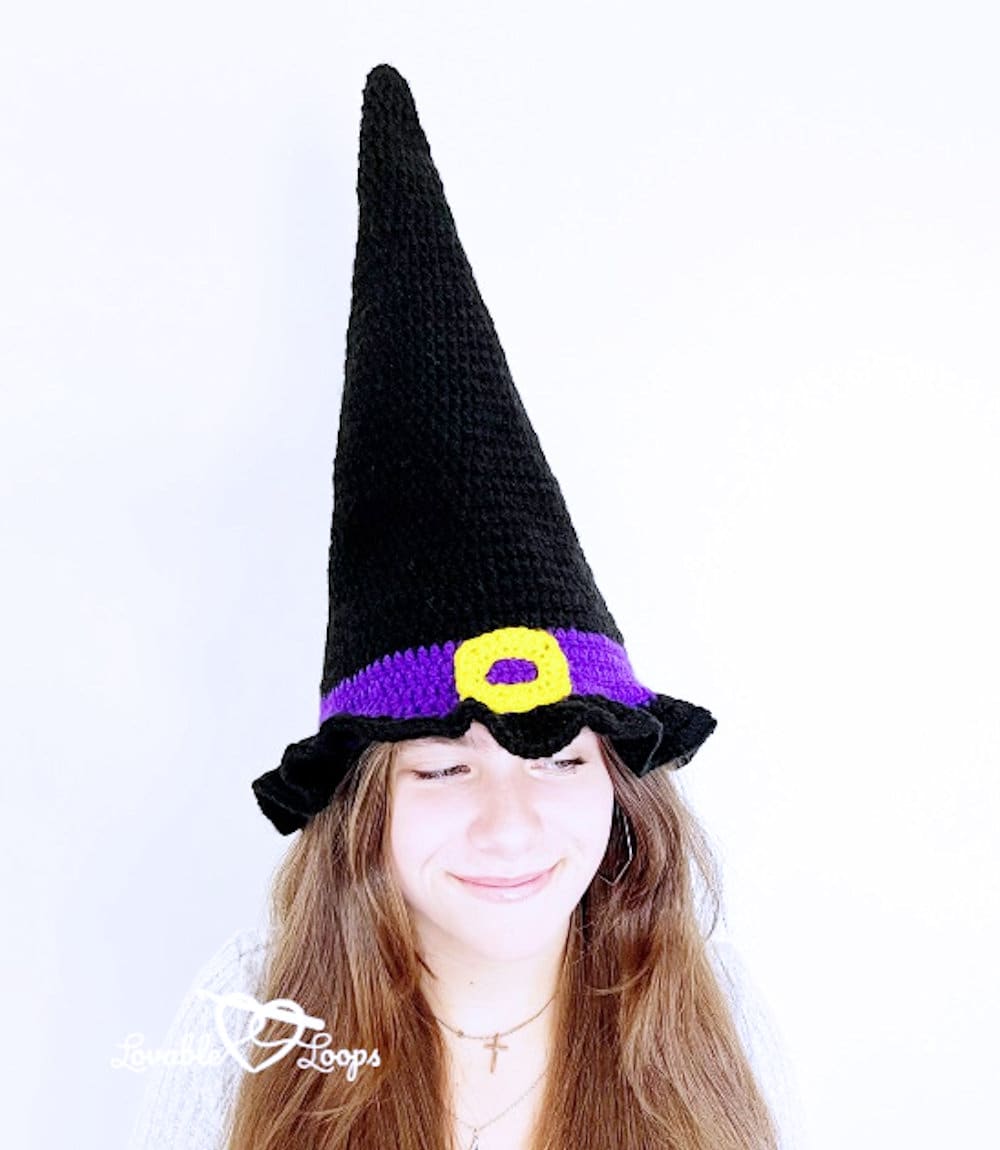 Model dressed in tall crocheted witch hat.