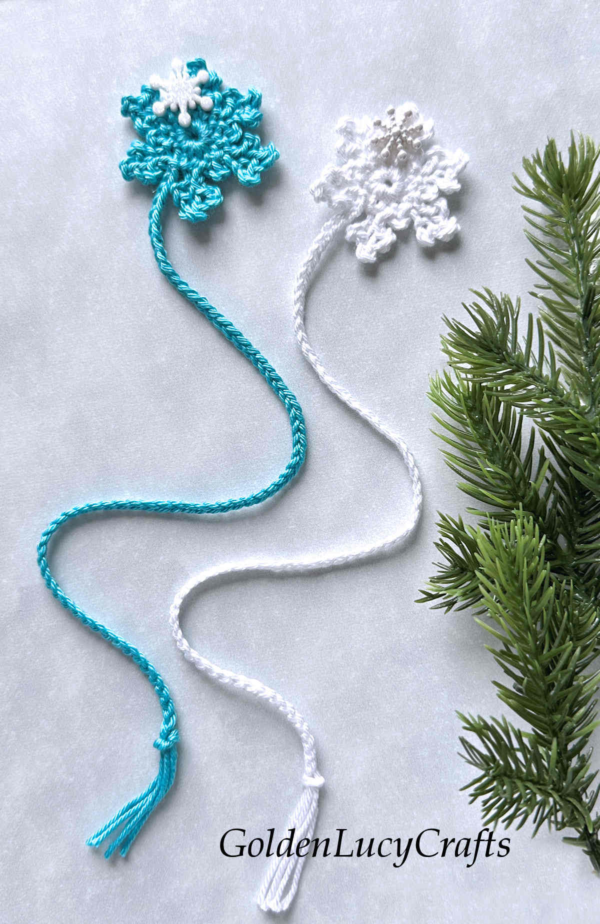 Crochet turquoise and white snowflake bookmarks.