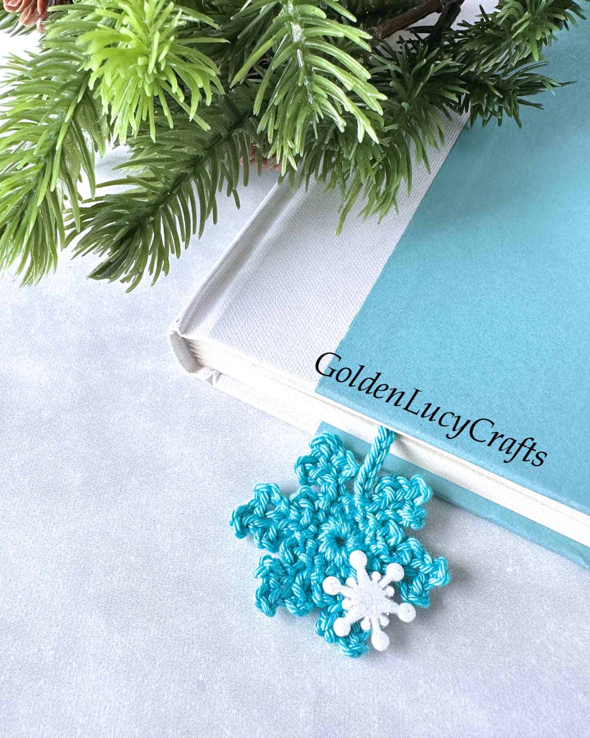 Crochet snowflake bookmark in the book.