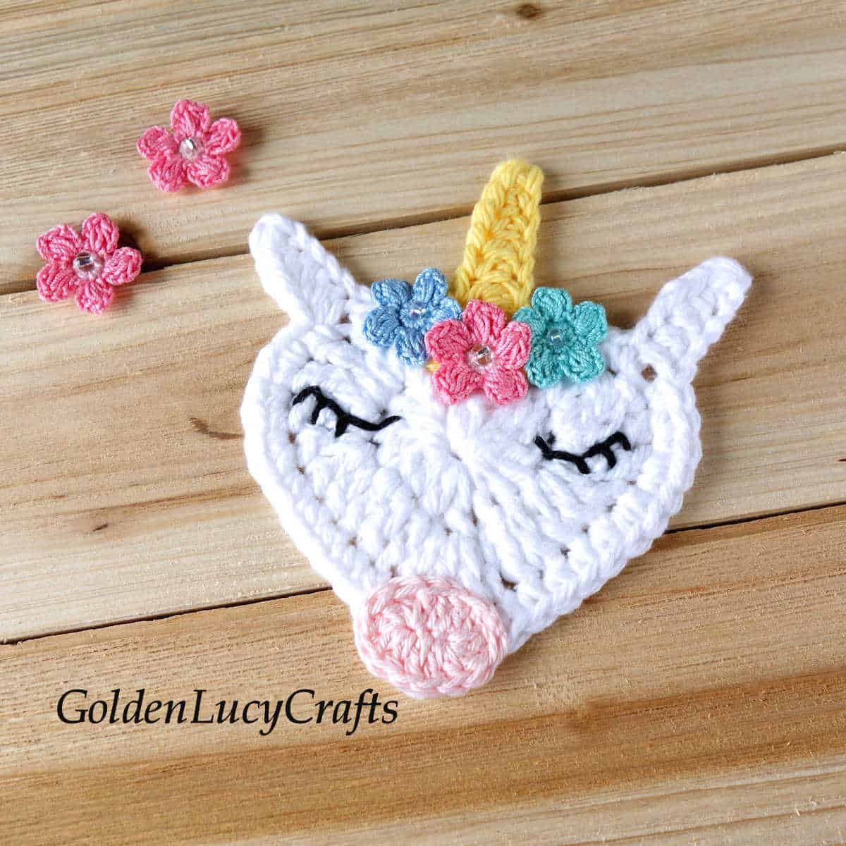 Crochet heart-shaped unicorn face applique.