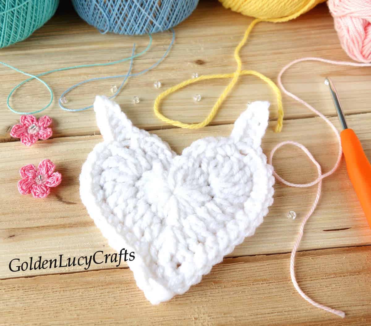 Process shot of crocheting heart unicorn applique.