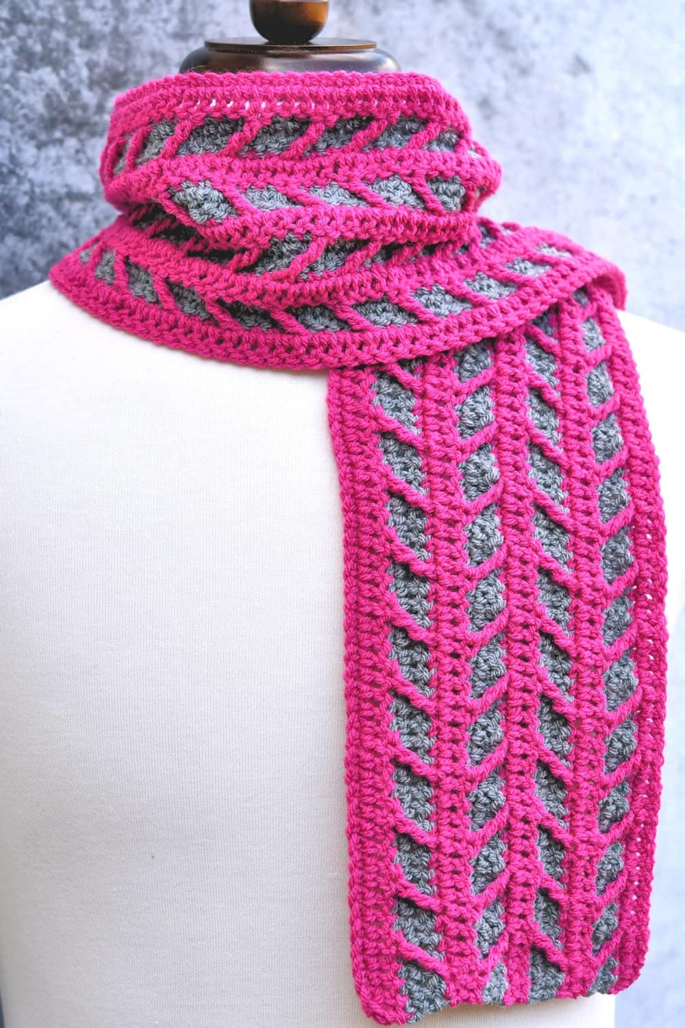 Crocheted pink and grey crocheted scarf.
