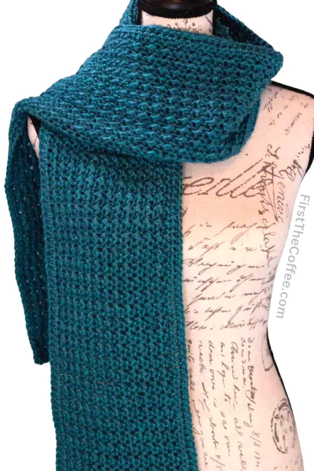 Crocheted dark green scarf.