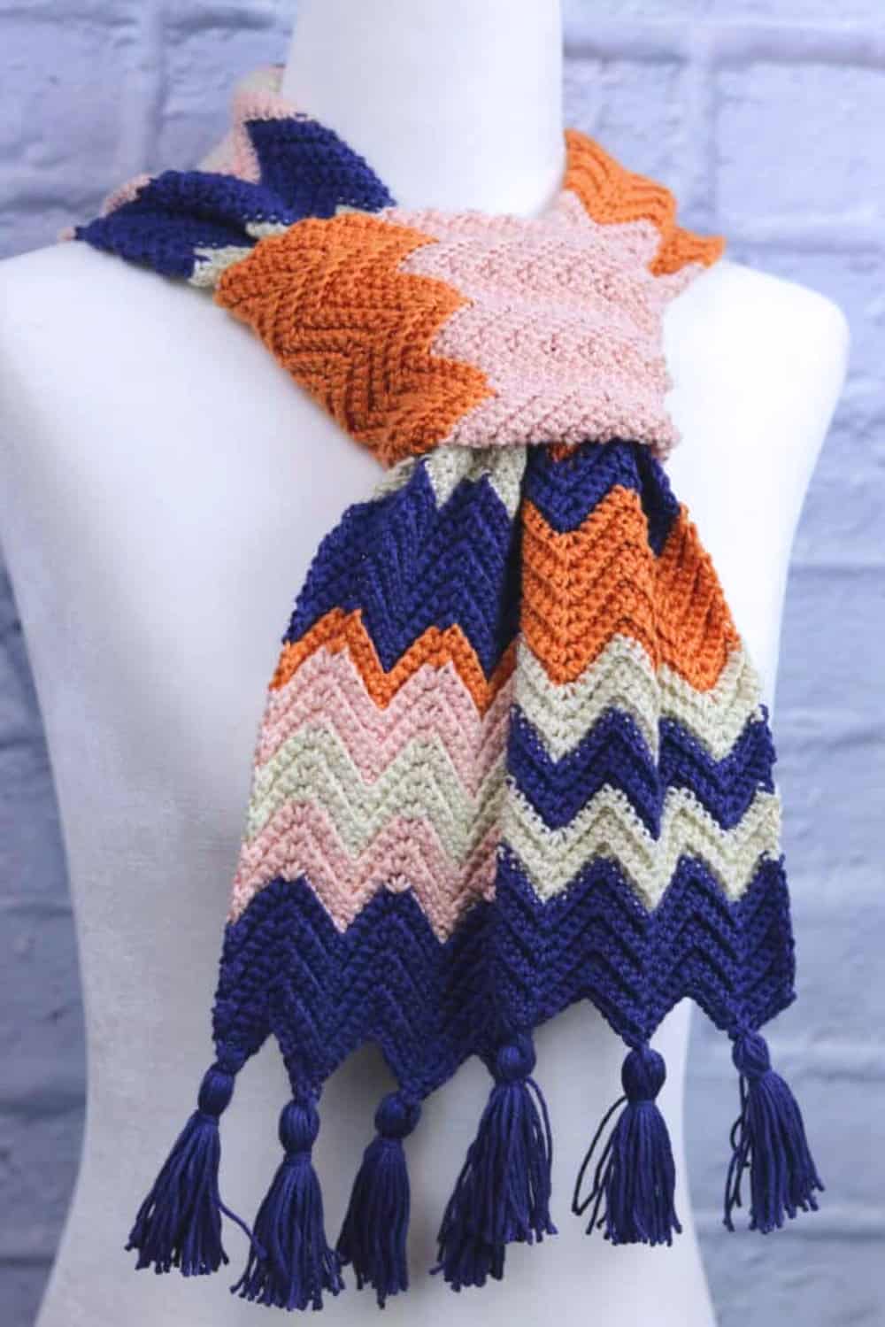 Colorful crocheted scarf made in a zig-zag pattern.