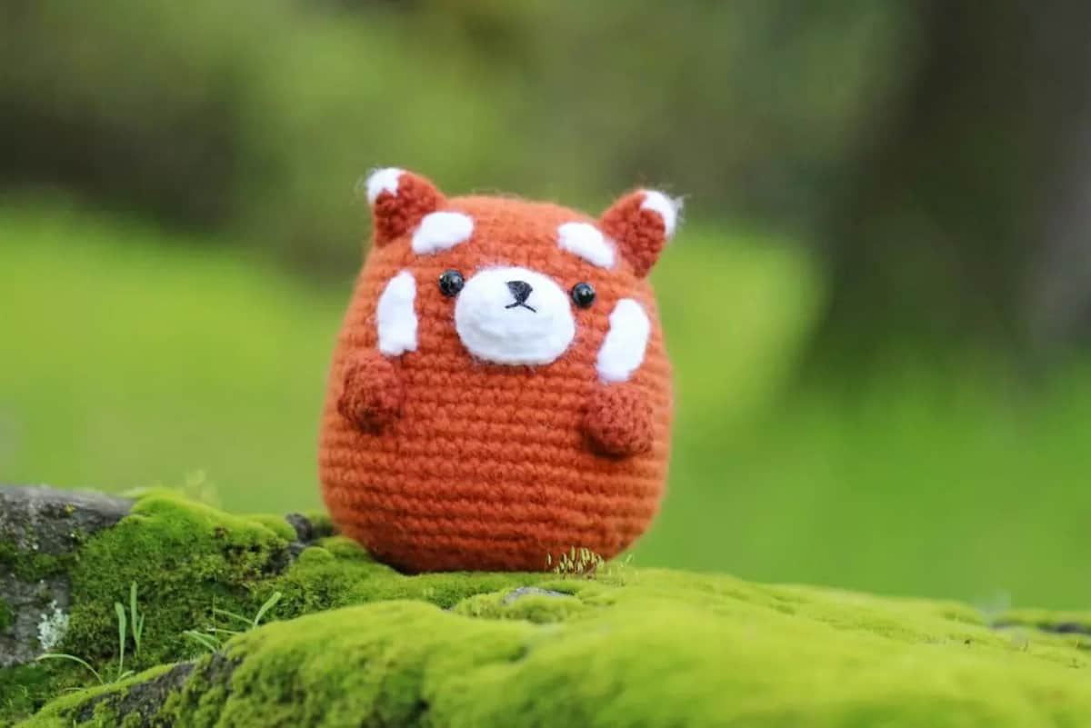 Crocheted red panda toy.