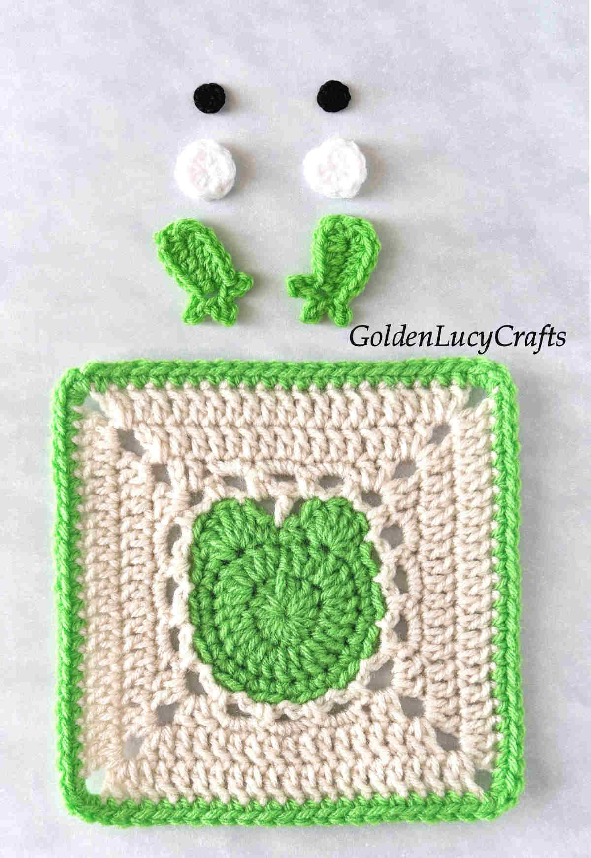 Parts of crocheted frog square.