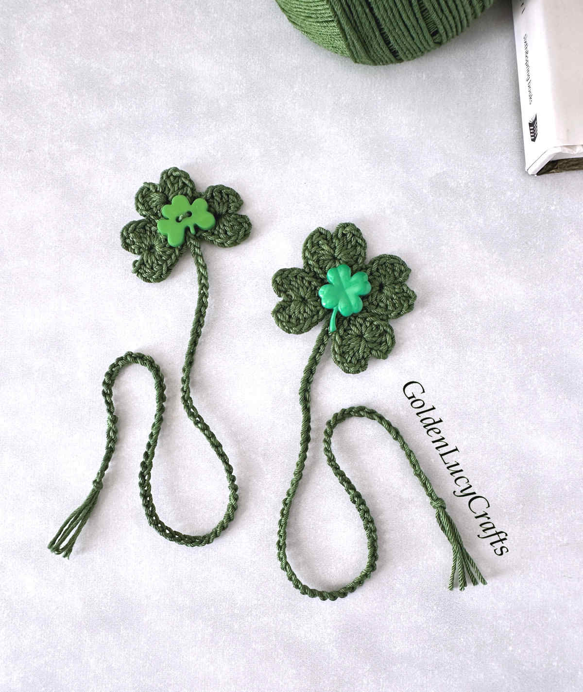 Two crocheted bookmarks - shamrock and four leaf clover bookmarks.