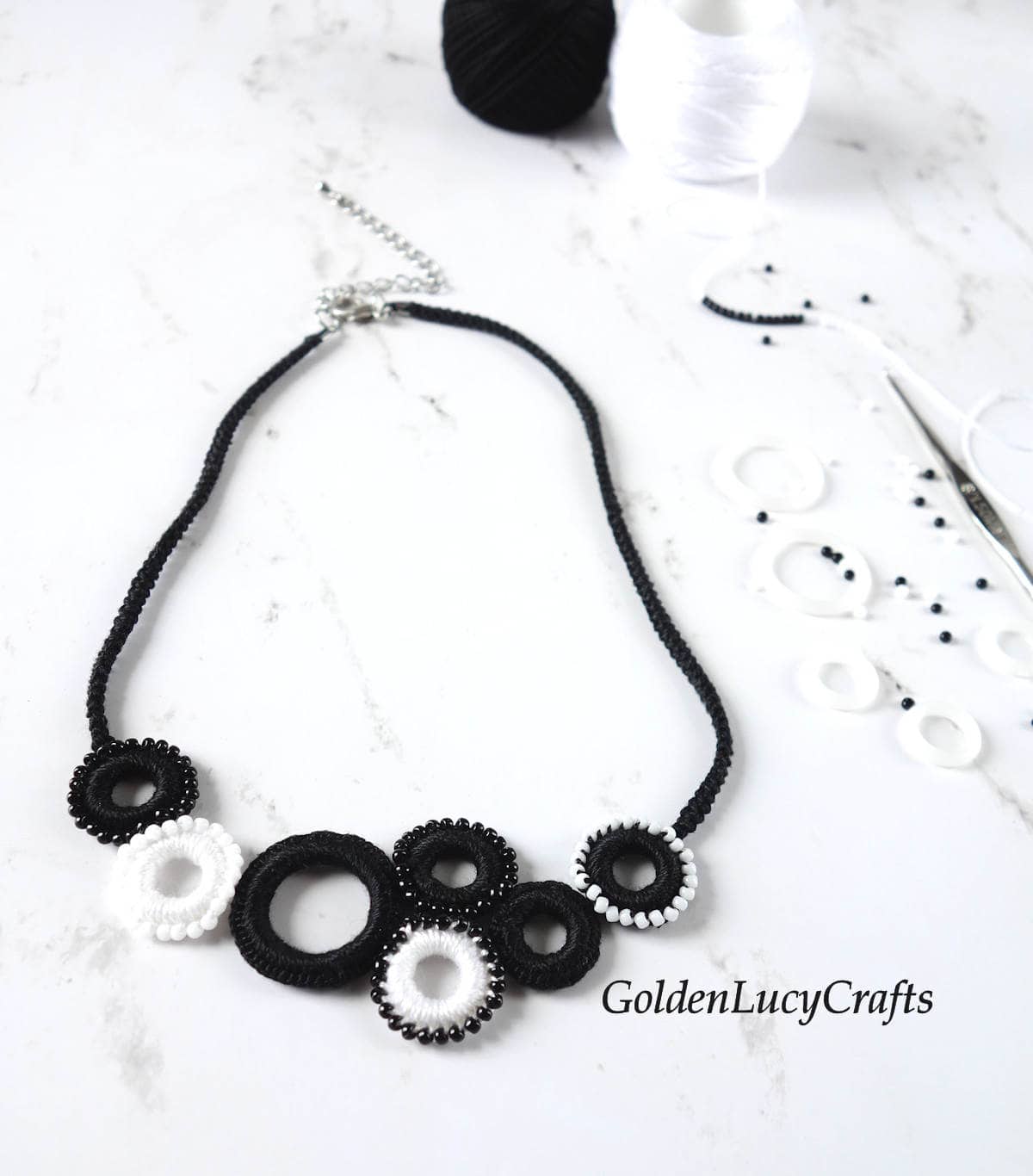 Crocheted necklace made of small black and white rings.