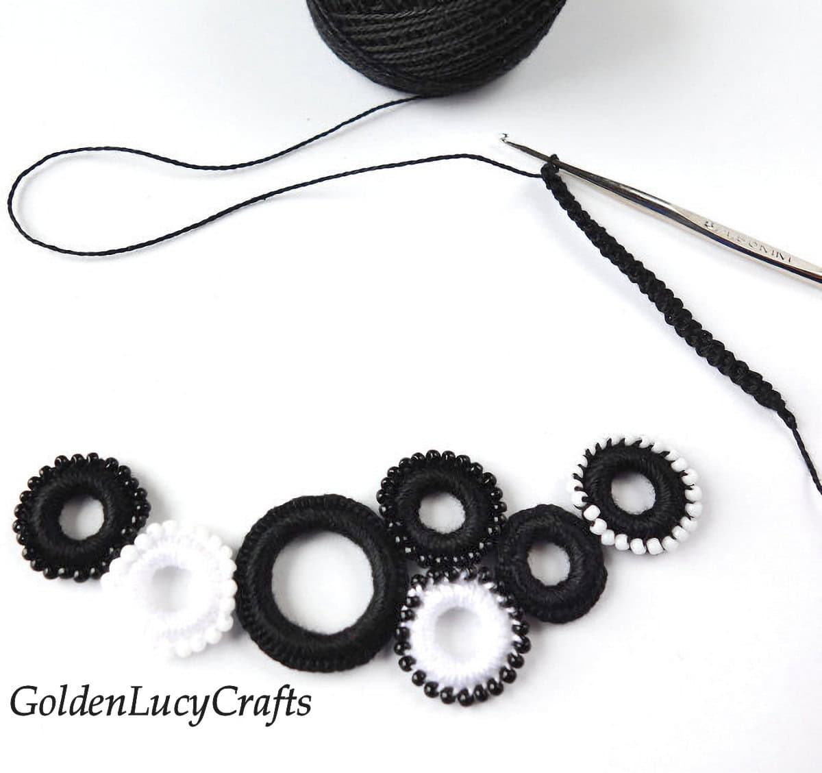 Process shot of making crocheted ring necklace.