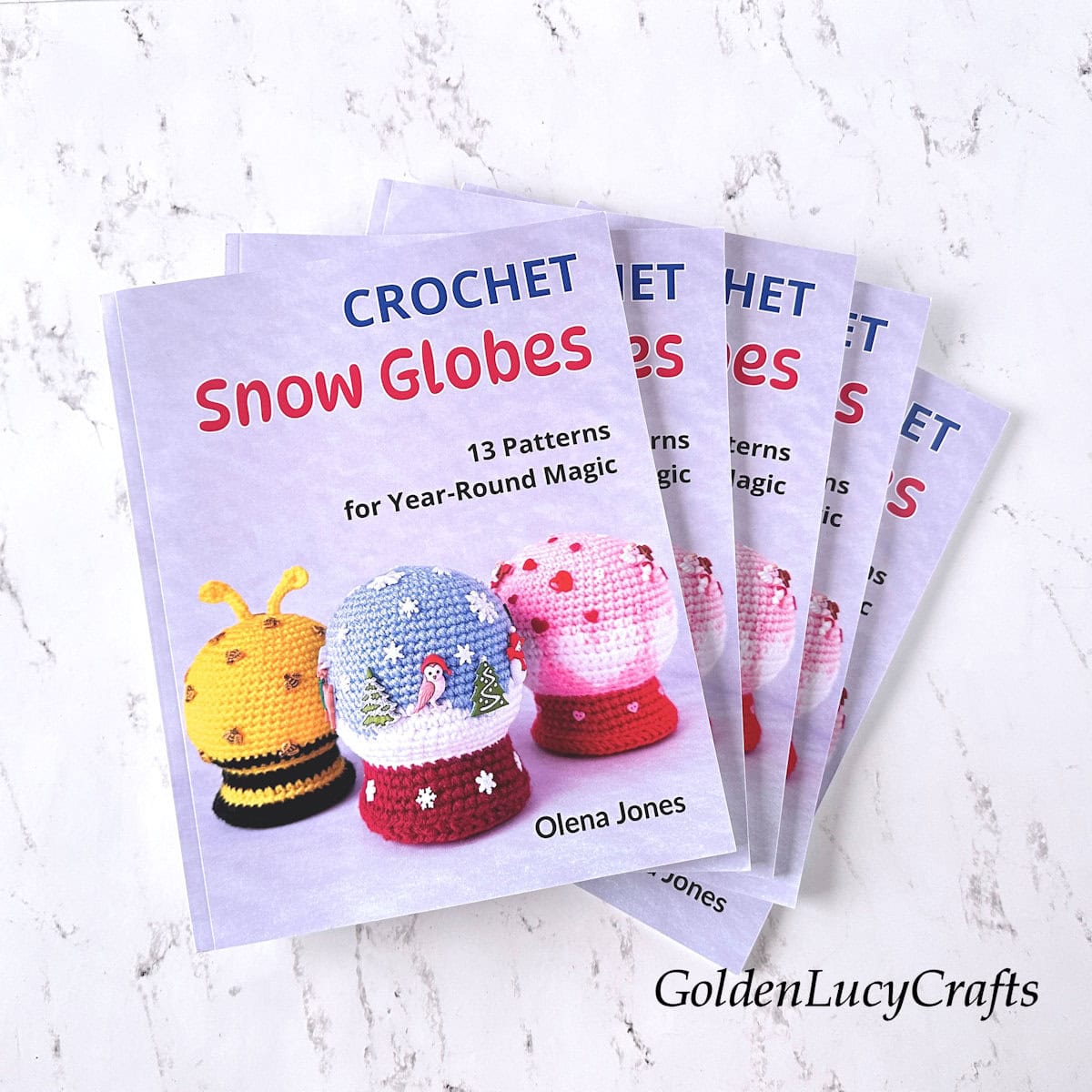 A stack of books titled "Crochet Snow Globes."