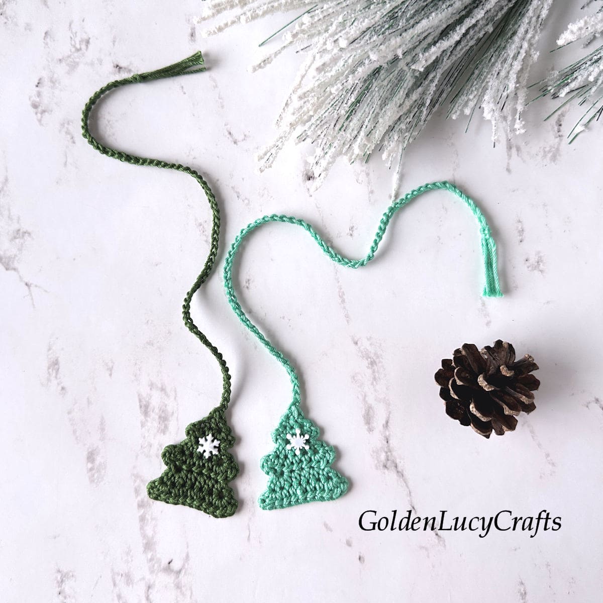 Two crocheted Christmas tree bookmarks.