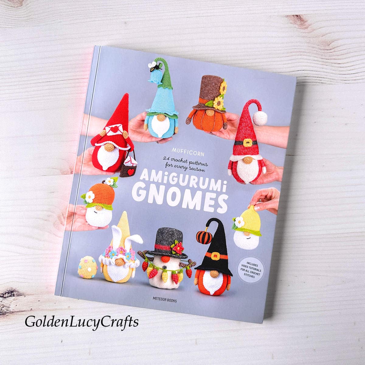 Amigurumi gnomes crochet book on a wooden background.