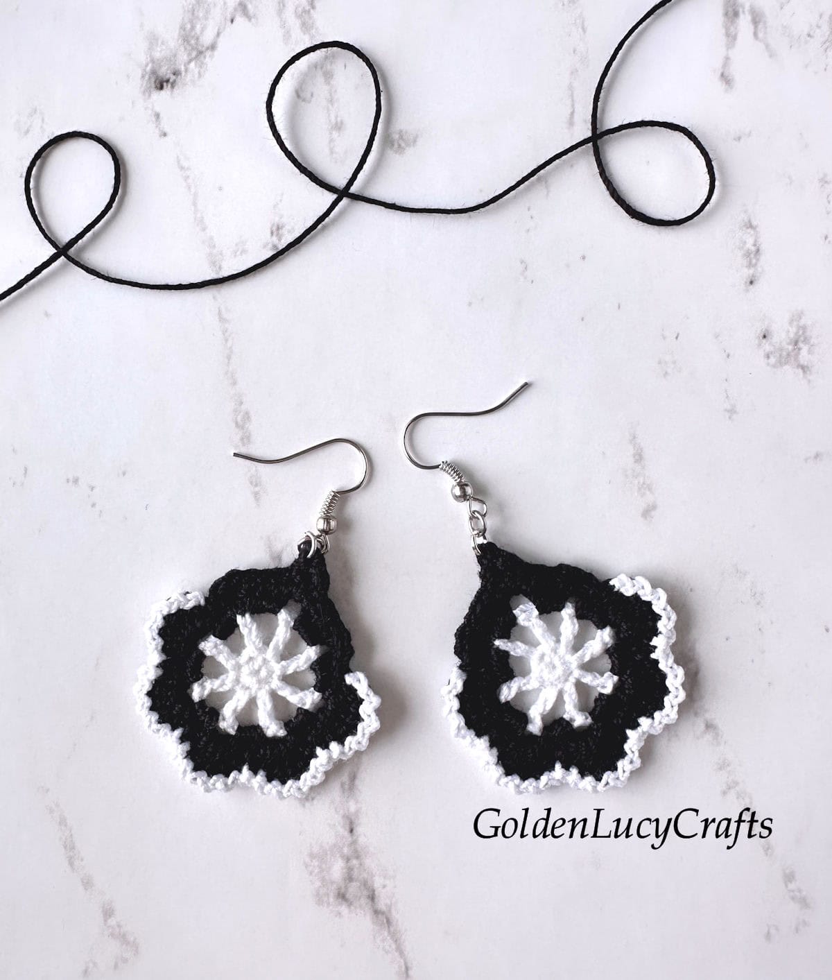Two crocheted earrings made in black and white.