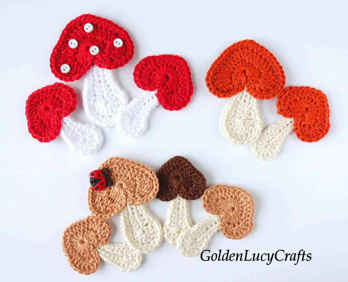 Crocheted appliques - mushrooms with heart-shaped caps.