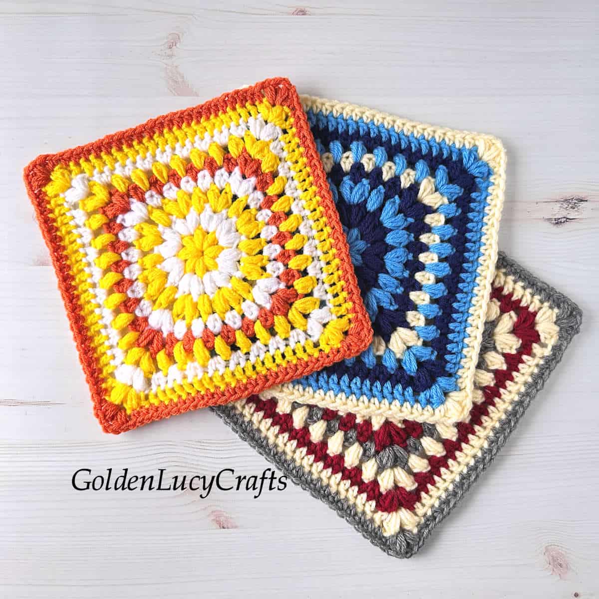 Three crocheted squares in various colors.