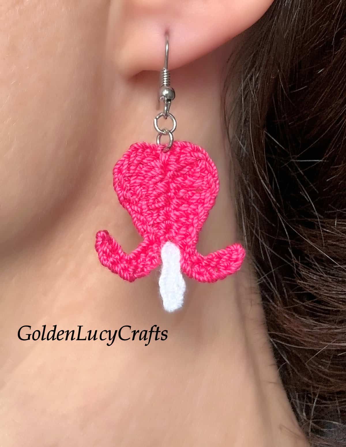 Crochet bleeding heart earring worn by the model.
