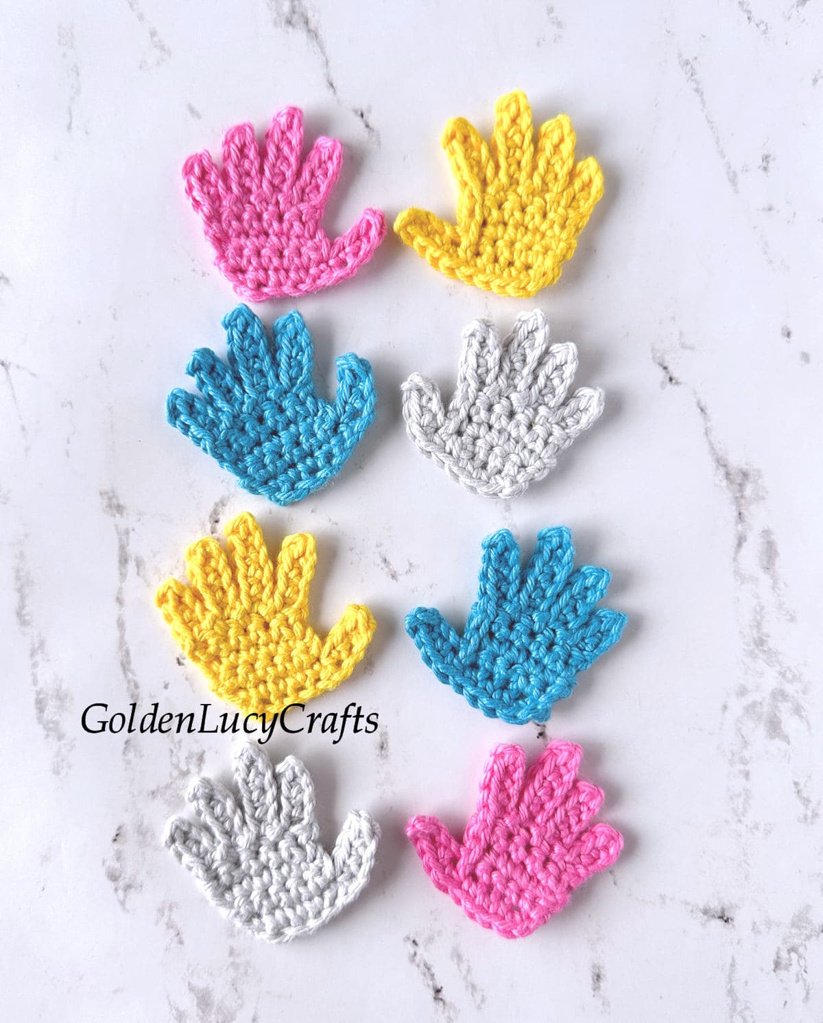 Crochet hand appliques in yellow, pink, blue, and gray colors.