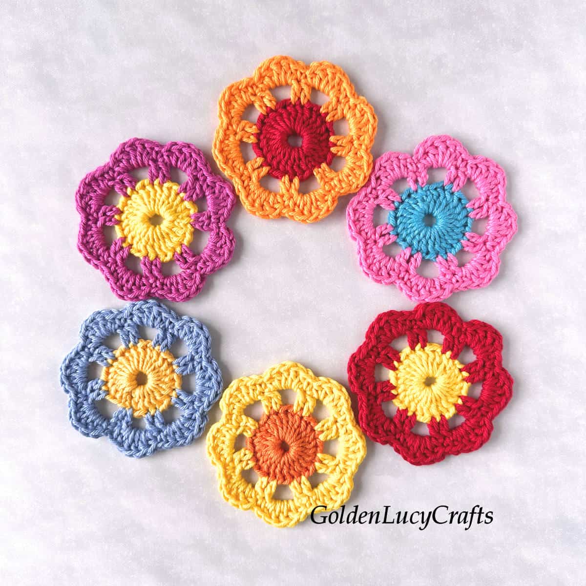 Six crocheted colorful flower motifs.