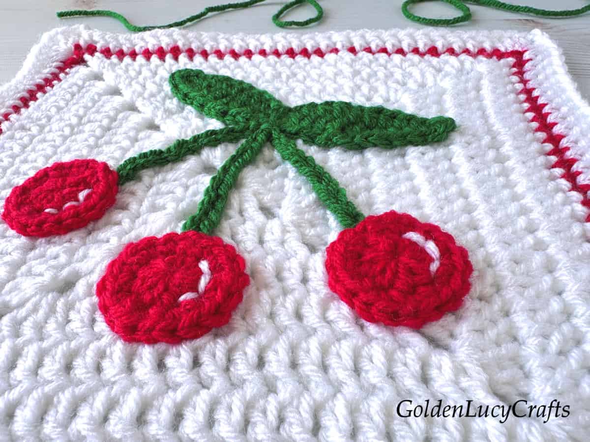 Crocheted cherry granny square close up picture.