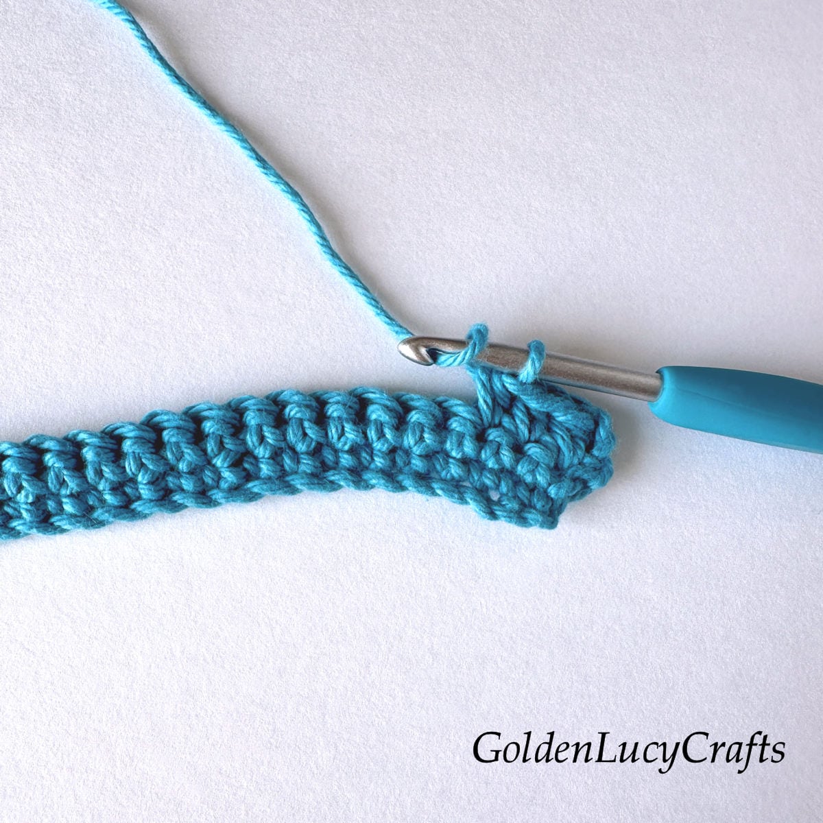 Crochet sample demonstrating Step 1 of how to work half double crochet 2 stitches together.
