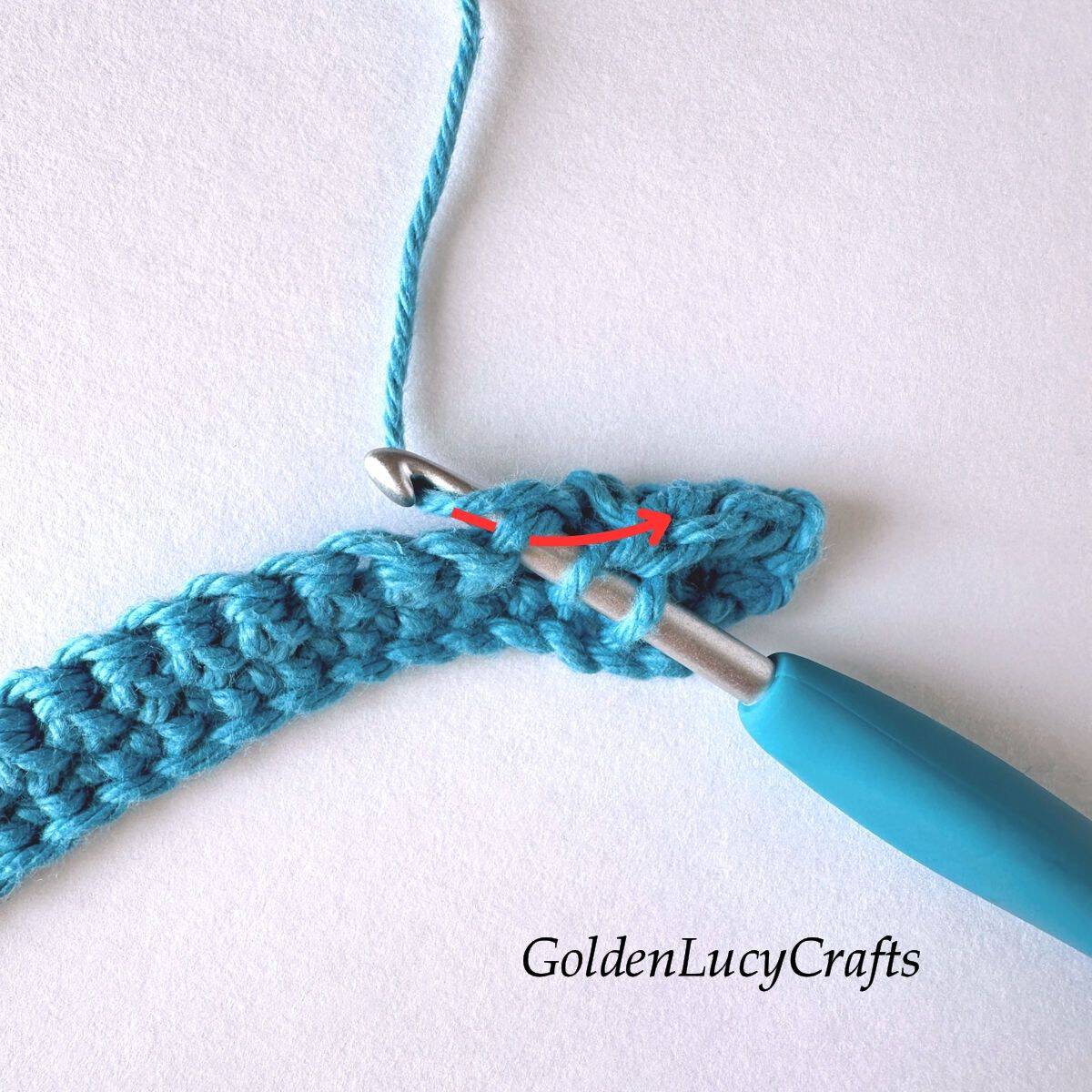 Crochet sample demonstrating Step 2 of how to work half double crochet 2 stitches together.