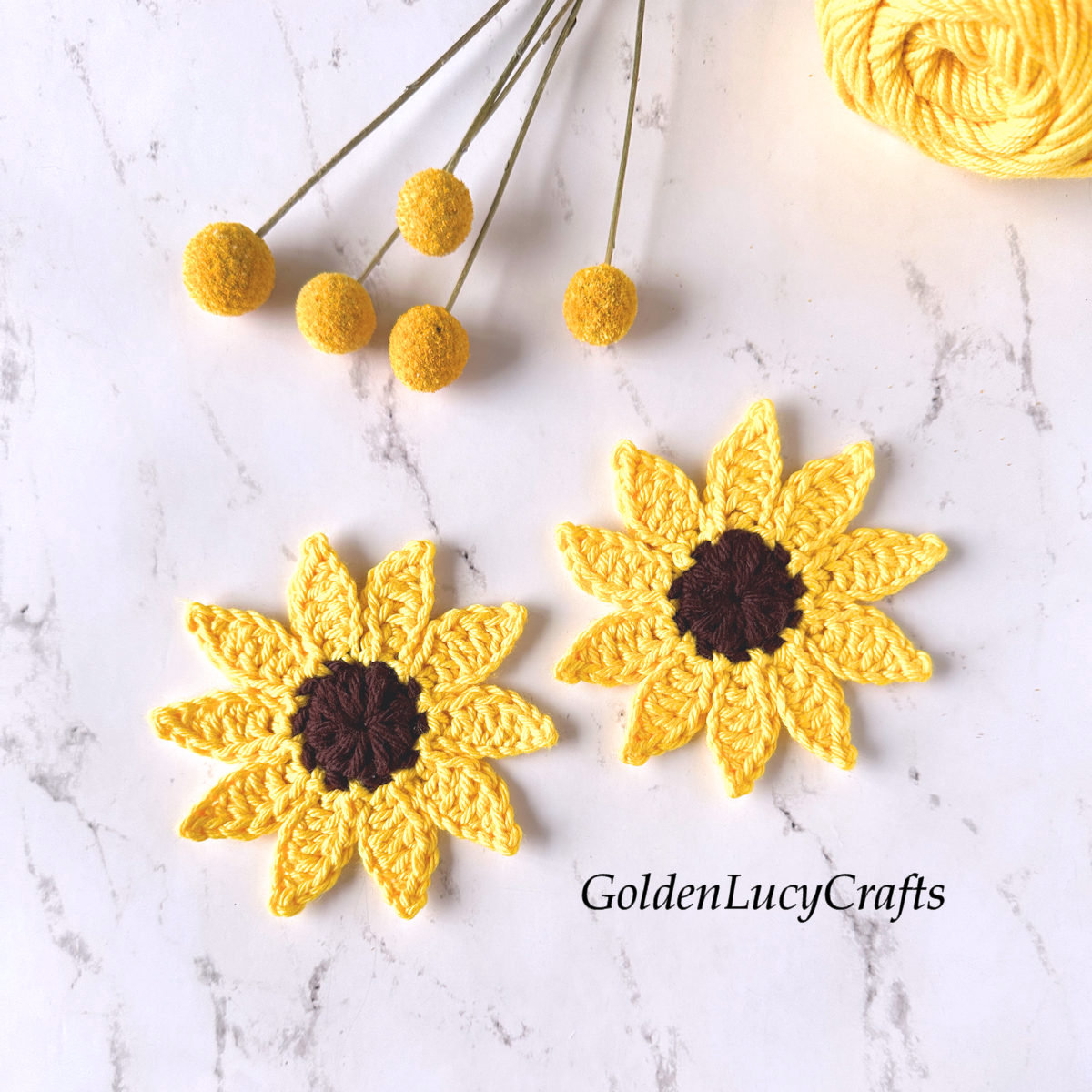 Two crocheted sunflower appliques.