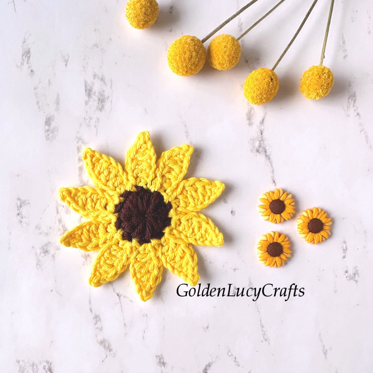 Crocheted sunflower applique, three small sunflower buttons.