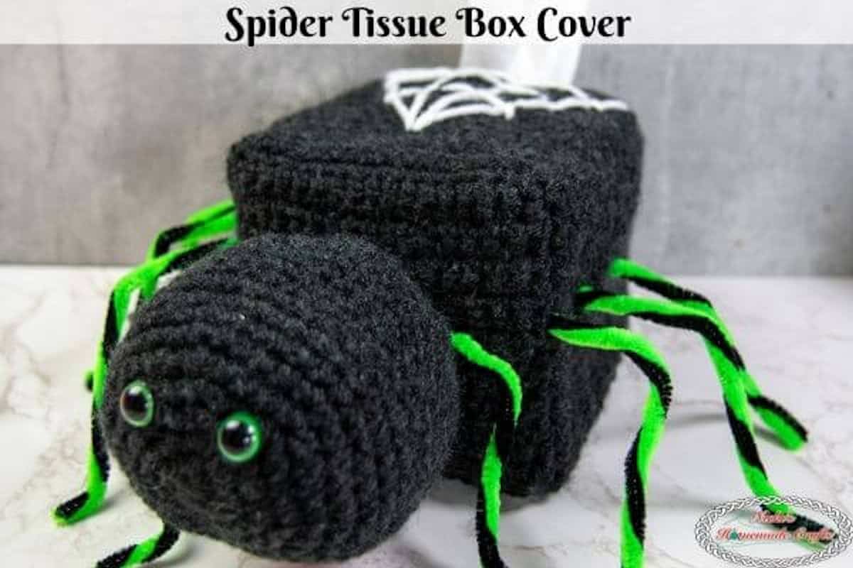 Crocheted black spider tissue box cover.